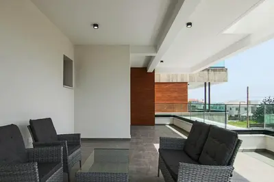a living room with two chairs and a large window at Phaedrus Living: City View Anna Residence 101 in Limassol