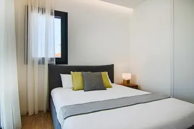 a bedroom with a large white bed with yellow pillows at Phaedrus Living: City View Anna Residence 102 in Limassol