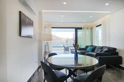 a living room with a table and a couch at Phaedrus Living: City View Anna Residence 102 in Limassol