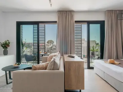 a living room with a couch and a table at Armonta Residences by BeCyprus in Limassol