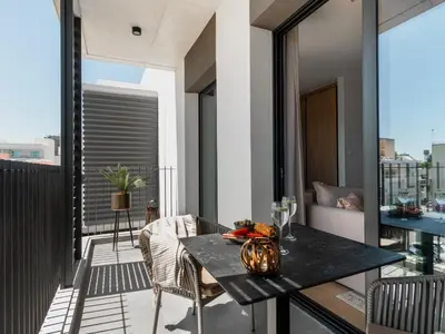a balcony with a table and chairs on a building at Armonta Residences by BeCyprus in Limassol