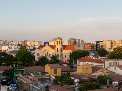 a view of a city with buildings and a church at Armonta Residences by BeCyprus in Limassol
