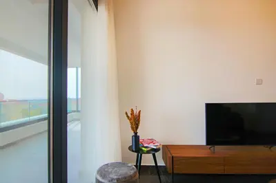 a living room with a flat screen tv and a table at Phaedrus Living: Sea View Anna Residence 201 in Limassol