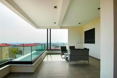 an empty living room with a view of a building at Phaedrus Living: Sea View Anna Residence 201 in Limassol