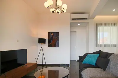 a living room with a couch and a flat screen tv at Phaedrus Living: Sea View Anna Residence 201 in Limassol