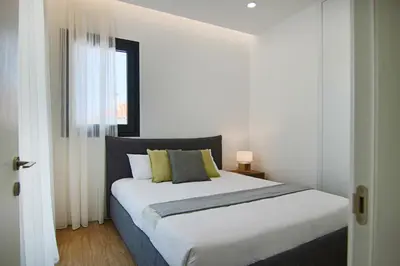 a bedroom with a large white bed with a window at Phaedrus Living: Sea View Anna Residence 202 in Limassol
