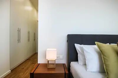 a bedroom with a bed and a table with a lamp at Phaedrus Living: Sea View Anna Residence 202 in Limassol