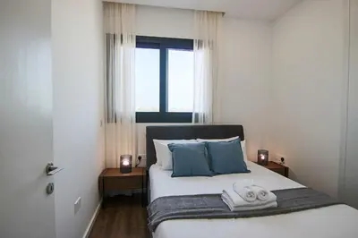 a bedroom with a bed with towels on it at Phaedrus Living: Sea View Anna Residence 302 in Limassol