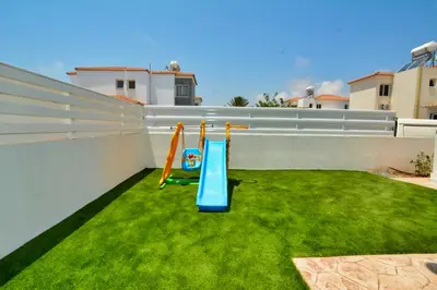 a small yard with a playground on a roof at Nissi Villa Sotia in Ayia Napa