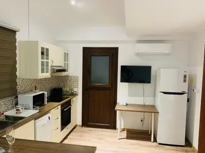 a kitchen with white appliances and a white refrigerator at STUDIO in CAPTAINS HOUSE WITH A POOL in Limassol