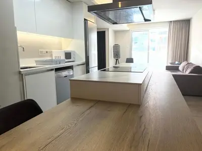 a kitchen with a table in the middle of a room at Central Business Suites Nicosia - Araouzou By Platform 357 in Nicosia