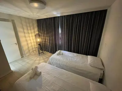 a hotel room with two beds and a lamp at Central Business Suites Nicosia - Araouzou By Platform 357 in Nicosia