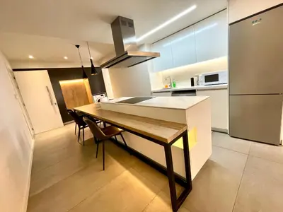 a kitchen with a table and a refrigerator at Central Business Suites Nicosia - Araouzou By Platform 357 in Nicosia