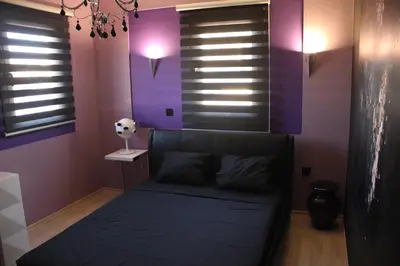a bedroom with purple walls and a bed in it at Purple Villa Protaras - Paralimni in Paralimni