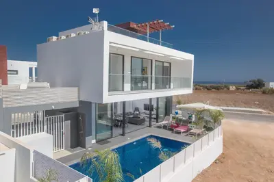 a large white house with a swimming pool at Anassa Seaview Villa - Stunning Panoramic Views in Protaras