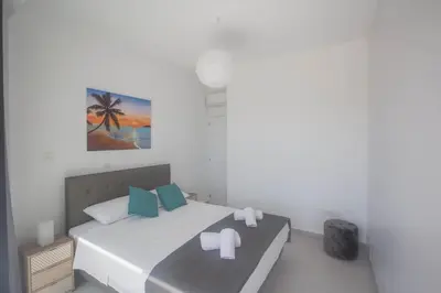 a bedroom with a bed and a painting on the wall at Anassa Seaview Villa - Stunning Panoramic Views in Protaras