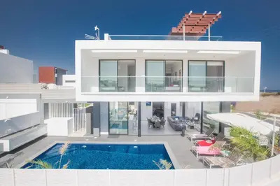 a large white house with a swimming pool at Anassa Seaview Villa - Stunning Panoramic Views in Protaras