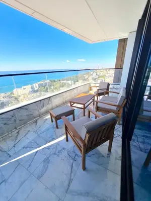 a balcony with benches and a view of the ocean at ICON - Private Holiday Apartments in Limassol