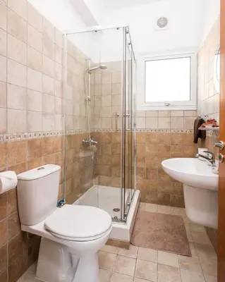 a bathroom with a toilet and a shower and a sink at Voroklini Villa with Pool in Larnaka