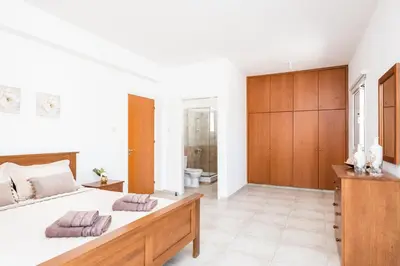 a bedroom with a large bed with two pillows on it at Voroklini Villa with Pool in Larnaka