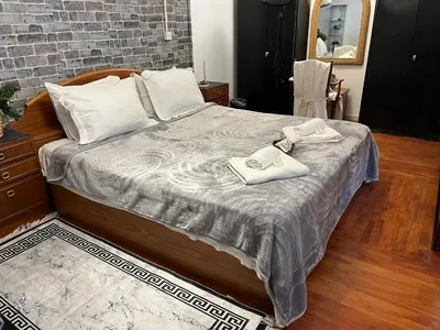 a bedroom with a bed with two towels on it at Lovely Cozy Apartment in the entrance of Nicosia in Aglantzia