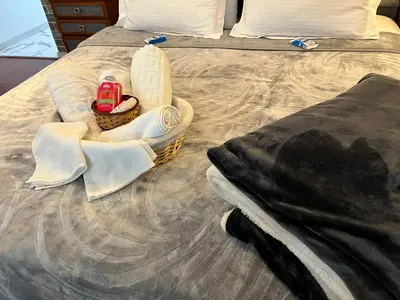 a basket on a bed with a towel on it at Lovely Cozy Apartment in the entrance of Nicosia in Aglantzia