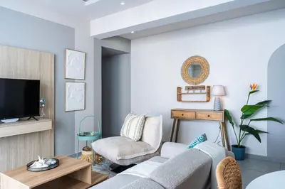 a living room with a couch and a chair at Beach Daze 1-BR Apt By Finikoudes Beach in Larnaka