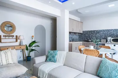a living room with a couch and a table at Beach Daze 1-BR Apt By Finikoudes Beach in Larnaka