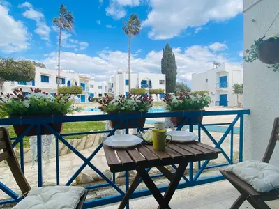 a table and chairs on a balcony with a view at Sea Breeze 1-BR Apt in Pyla in Pyla