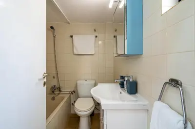 a small bathroom with a toilet and a sink at Sea Breeze 1-BR Apt in Pyla in Pyla