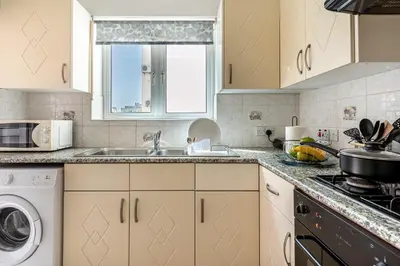a kitchen with a sink and a dishwasher at Sweet retreat 2-BR Apartment in Mackenzie in Larnaka