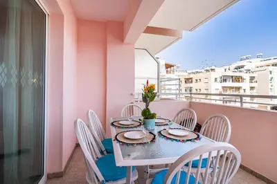 a table on a balcony with a table and chairs at Sweet retreat 2-BR Apartment in Mackenzie in Larnaka