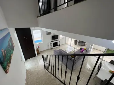 an overhead view of a living room with a staircase at Crystal 12 Kapparis 3Bedroom Villa in Paralimni