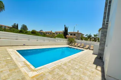 a swimming pool in the backyard of a house at Crystal 12 Kapparis 3Bedroom Villa in Paralimni