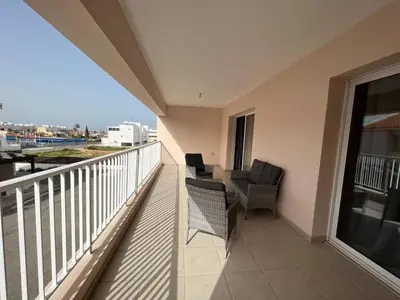 a balcony with two chairs and a table on a balcony at Greek Harmony Apartment in Paralimni