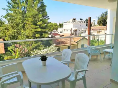 a white table and chairs on a balcony at Dinglis Residences 31 in Larnaka