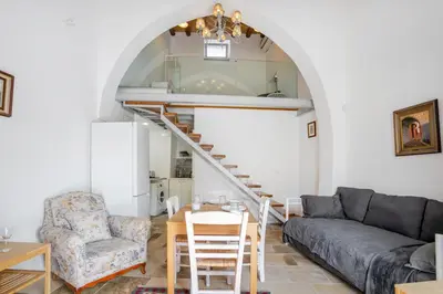a living room with a couch and a table at To Hani - Kamara Studio in Nicosia