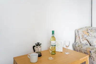 a table with a bottle of wine and two glasses at To Hani - Kamara Studio in Nicosia