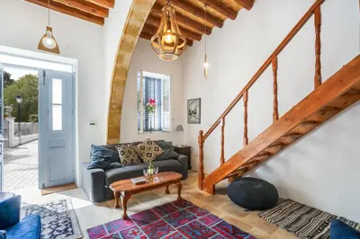 a living room with a couch and a table at To Hani - Kamara Maisonette in Nicosia