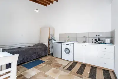 a kitchen with a washer and dryer in a room at To Hani - Small Studio in Nicosia