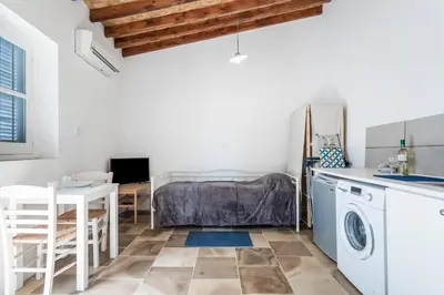 a kitchen with a washing machine and a table at To Hani - Small Studio in Nicosia