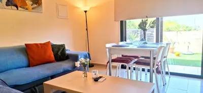 a living room with a couch and a table at AFRODITI APARTMENTs in Pervolia