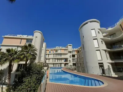 a large building with a swimming pool in front of it at Hestia Living in Scala