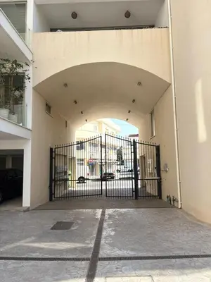 an entrance to a building with a black gate at Hestia Living in Scala