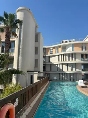 a swimming pool in front of a building at Hestia Living in Scala