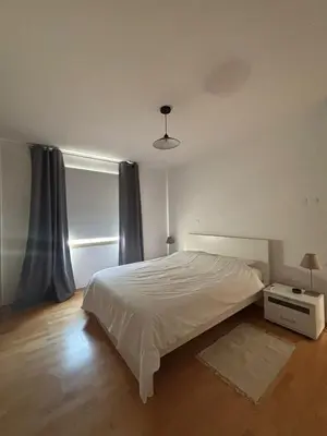 a bedroom with a white bed and a window at Hestia Living in Scala