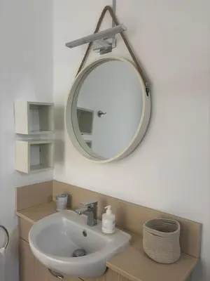 a bathroom with a sink and a mirror on the wall at Hestia Living in Scala