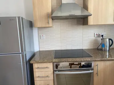 a kitchen with a refrigerator and a stove top oven at Great Kings Resort, Kapparis, Cyprus - Self Catering Apartment, Sleeps 6 in Paralimni