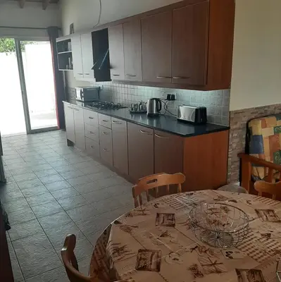 a kitchen with a table and chairs and a kitchen with a table and a table at HAVEN HOUSE in Larnaka