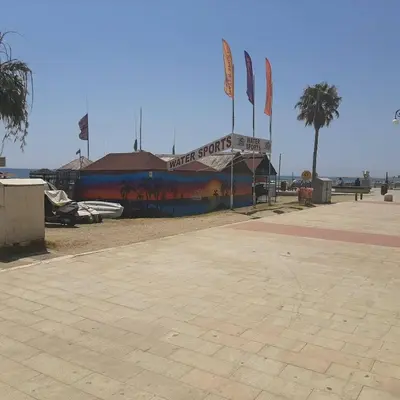 a building with flags on it next to the beach at HAVEN HOUSE in Larnaka